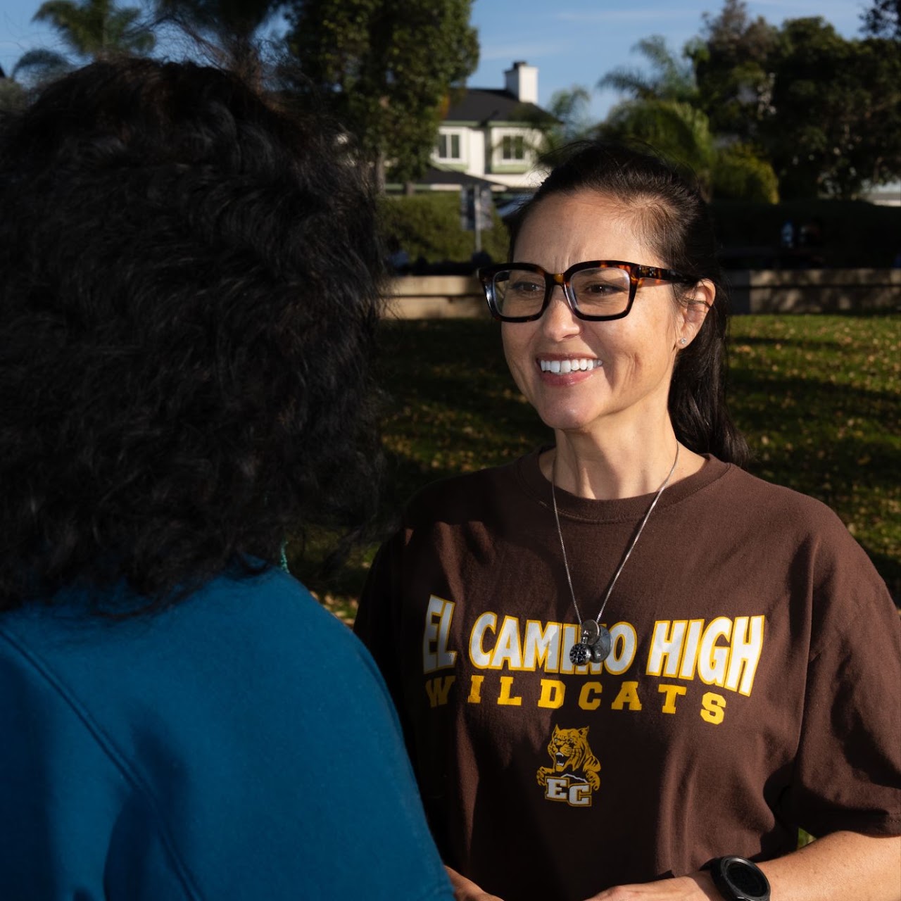 Neighbors talking with Emily Gonzales about housing costs and affordability at a District 2 community event in Oceanside